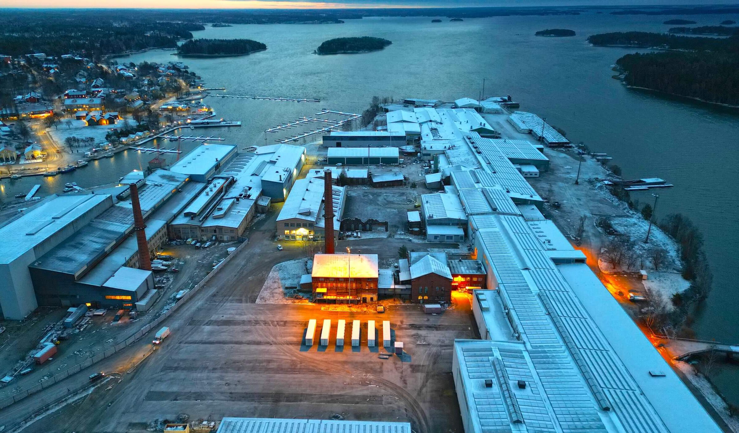 Archived site view in Southern Finland, with coastal industrial buildings and evening light.